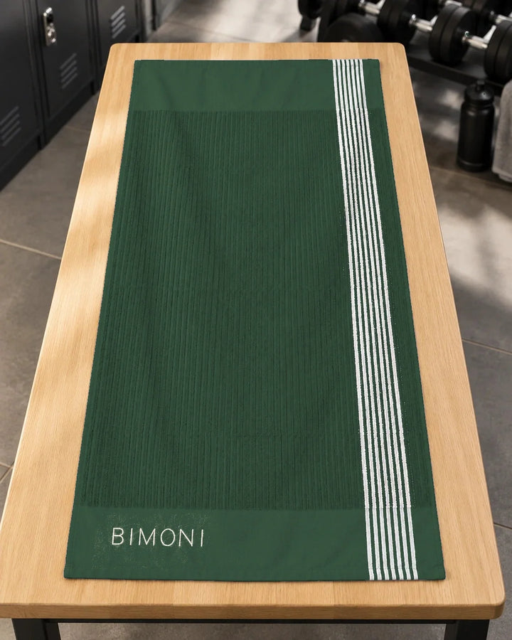 BIMONI serviette – Vert – Posée à plat dans l’espace fitness