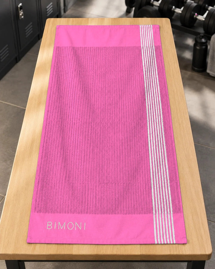 BIMONI serviette – Rose – Posée à plat dans l’espace fitness